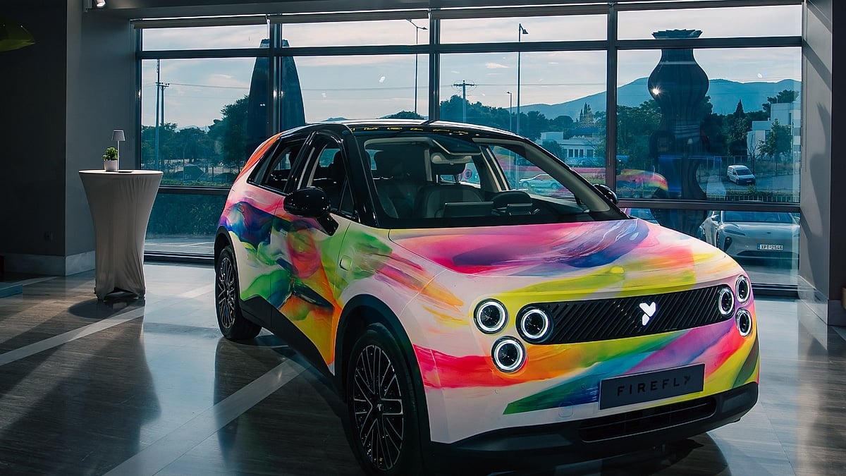 Vibrant, colorful Firefly electric car showcased in a sleek showroom.
