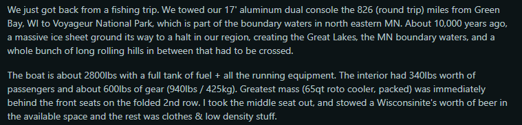 A 17-foot aluminum boat on a trailer, surrounded by scenic landscapes after a fishing trip to Voyageur National Park.