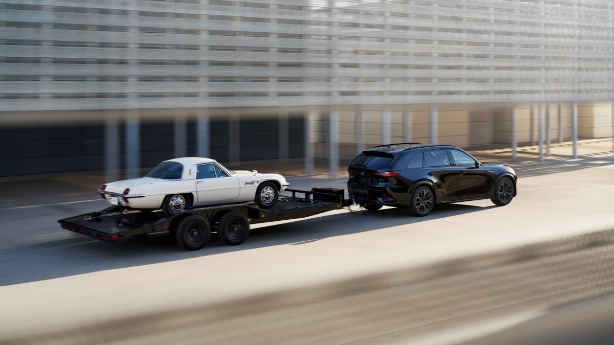 2025 Mazda CX-70 utilizing its 5,000-pound towing capacity while towing a Mazda Cosmo