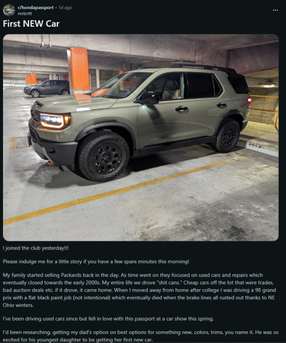 A new olive-green Honda Passport parked in a dimly lit garage, showcasing its rugged design and black wheels.