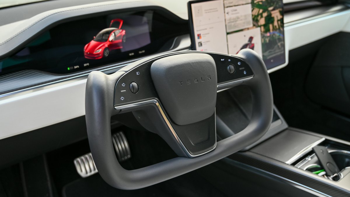Tesla Model S Plaid Interior steering wheel with red vehicle in the HUD