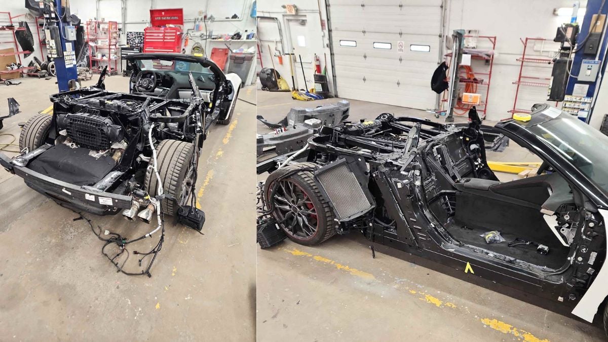 A stripped-down C8 Corvette in a garage, showcasing its bare frame, wheels, and interior components, with tools and equipment nearby.
