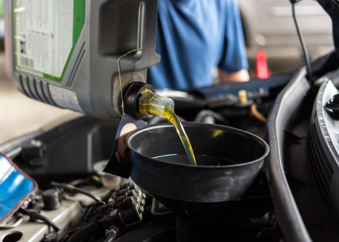 Pouring engine oil into a car