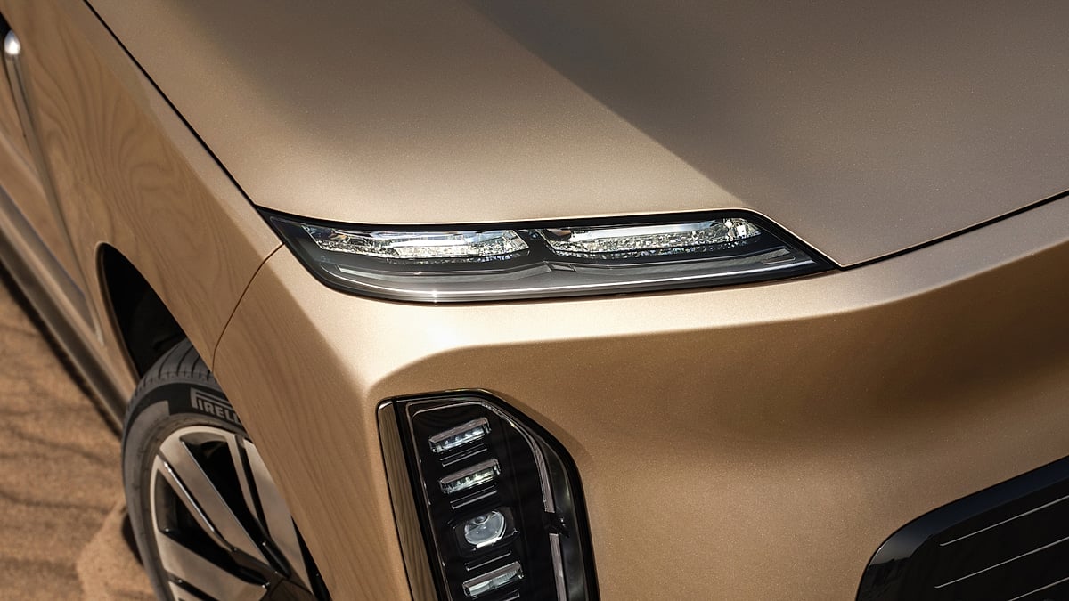 Close-up of the Nio ES9 headlight and front fascia in desert light