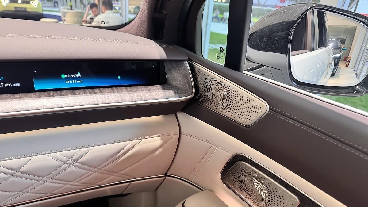 Nio ES9 interior showing the front passenger door panel, speaker grille and dashboard display