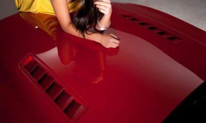 Dalena Henriques on the hood of the 2013 Ford Mustang GT