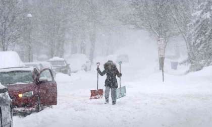 A Vehicle Owner Starts To Dig Out From A Blizzard