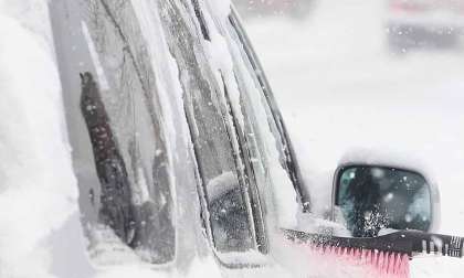 Snow-covered car cleaned in polar vortex time.