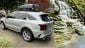 Silver Kia Sorento from the side and small waterfall